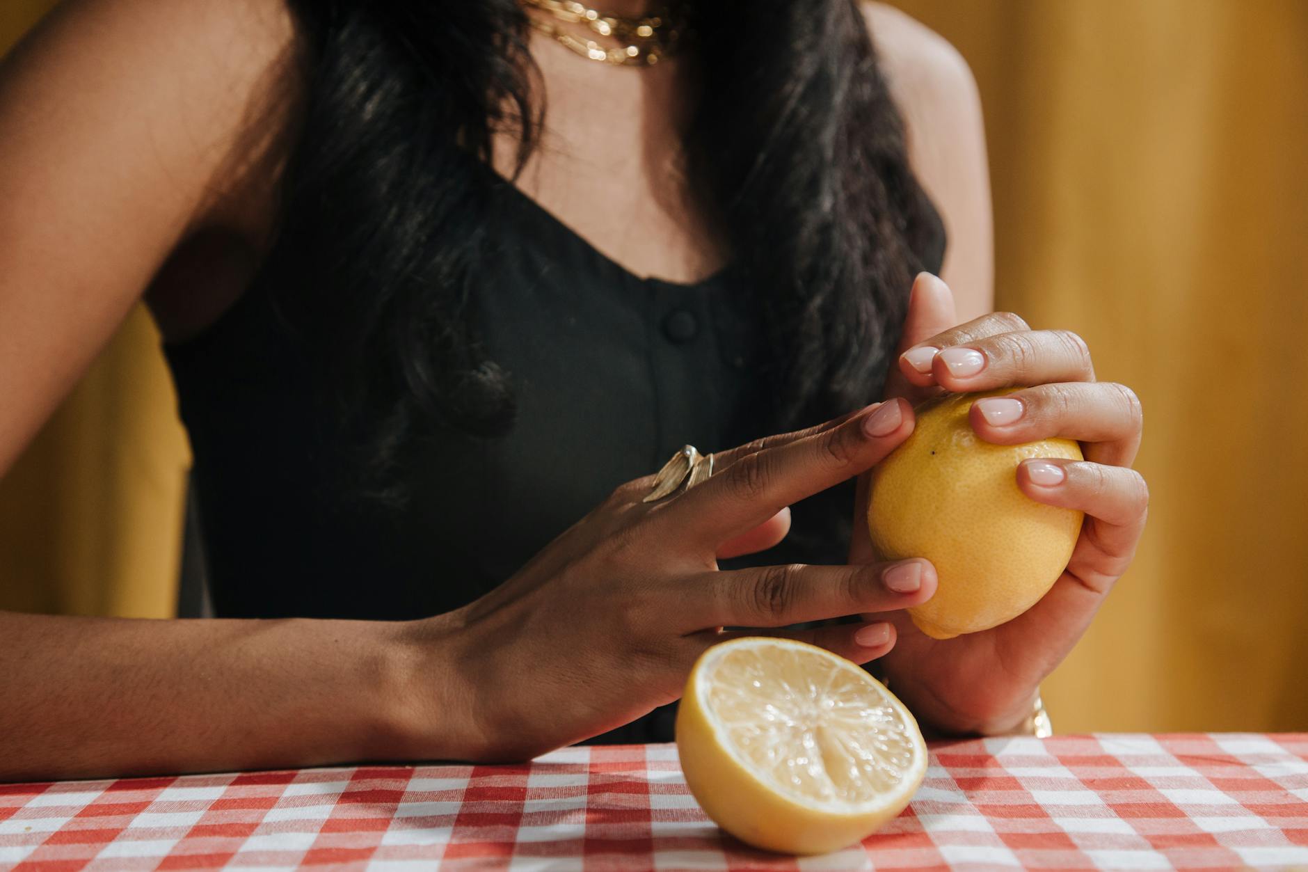 Fresh lemon halves on a pink background in natural light