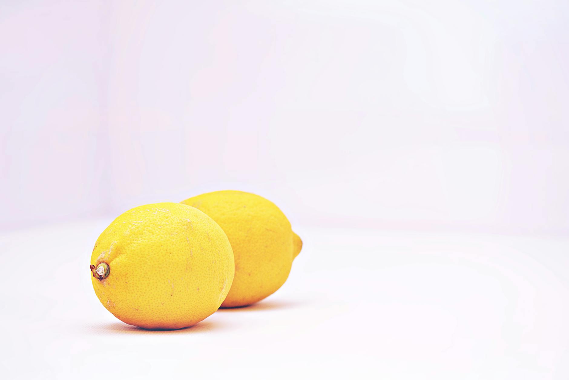 Two fresh lemons on a white background, symbolizing the Lemon Clitoral Vibrator experience