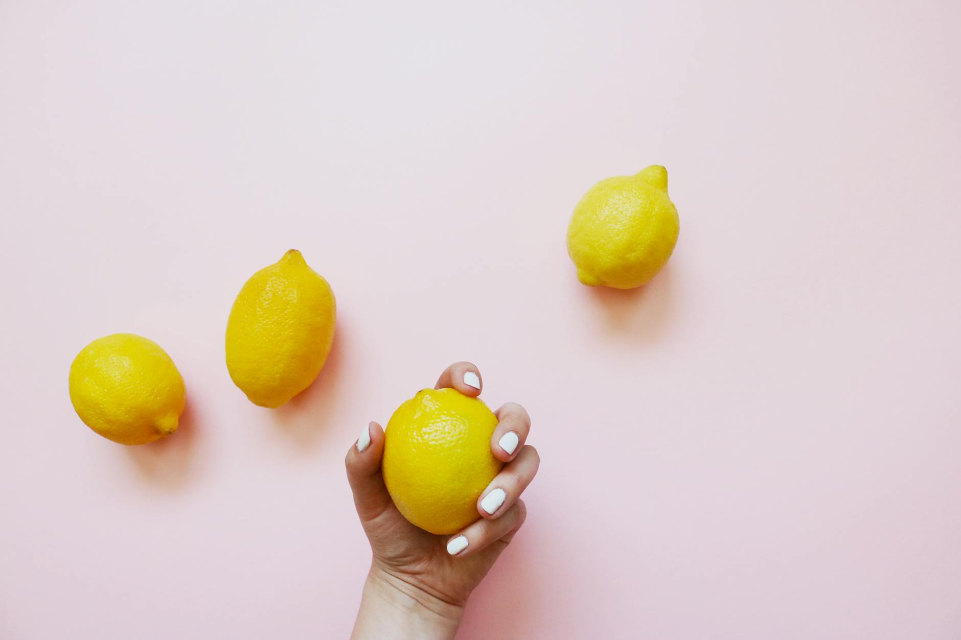 Hands holding pastel-colored silicone vibrators for pleasure exploration