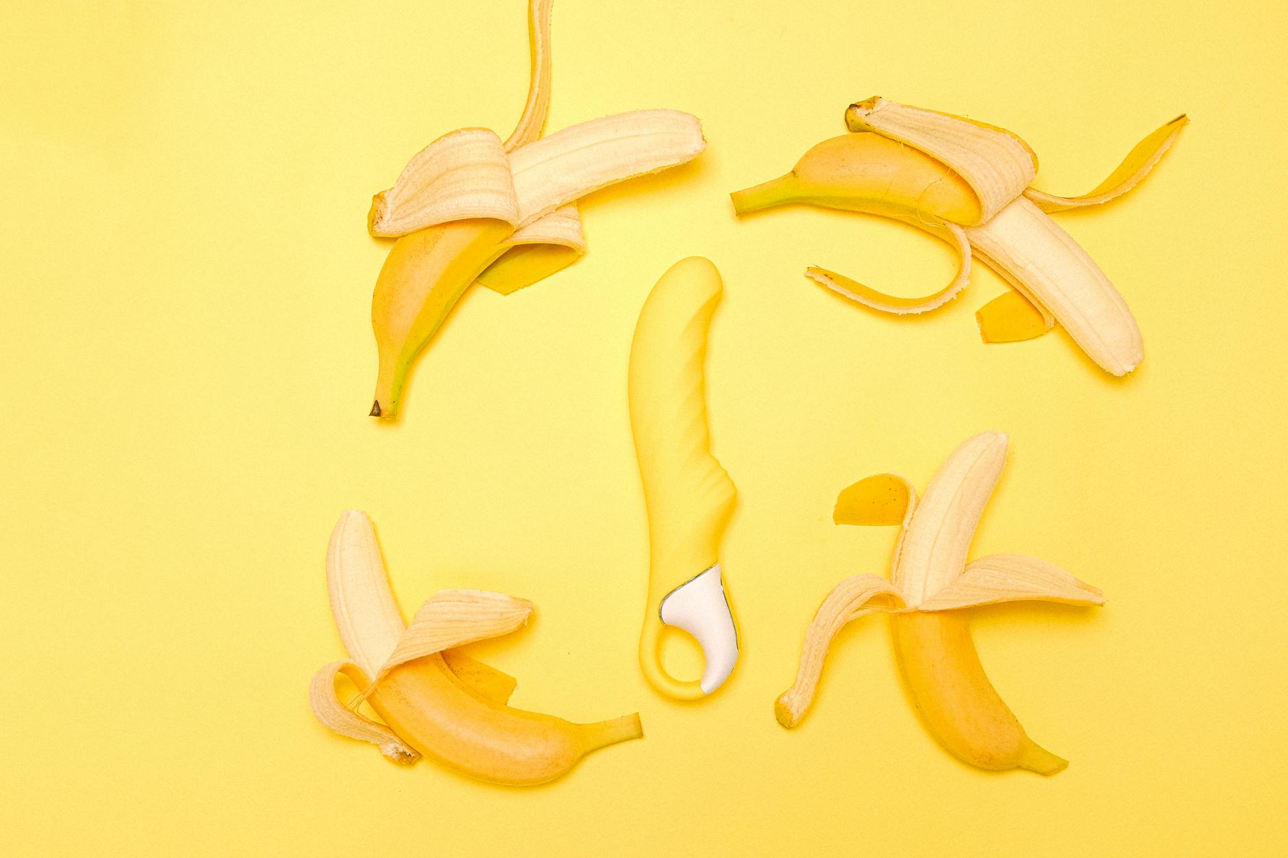 Yellow lemon-shaped clitoral vibrator on soft fabric, representing pleasure during postpartum healing