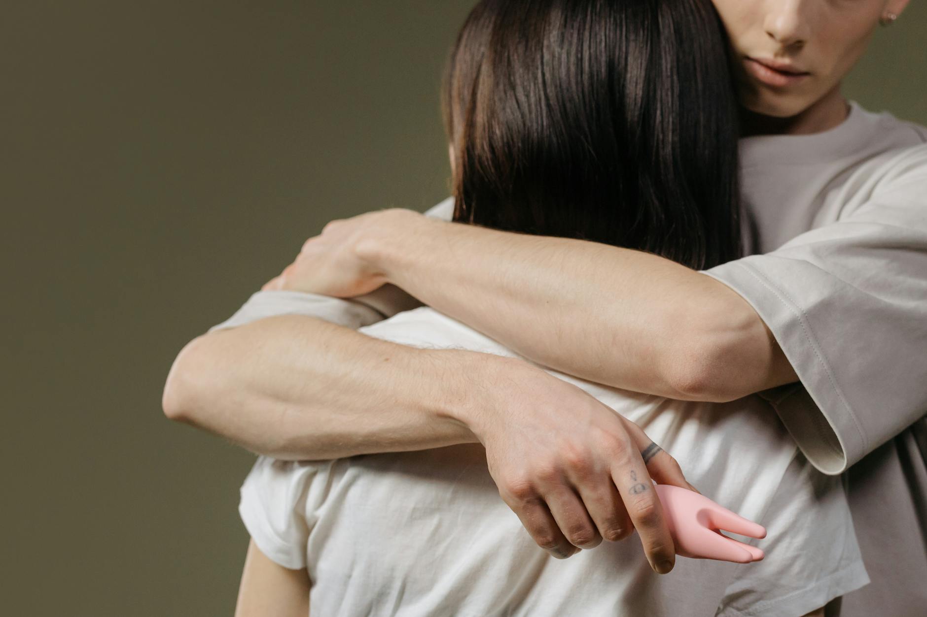 A close-up of hands held together, representing emotional intimacy and connection during healing.