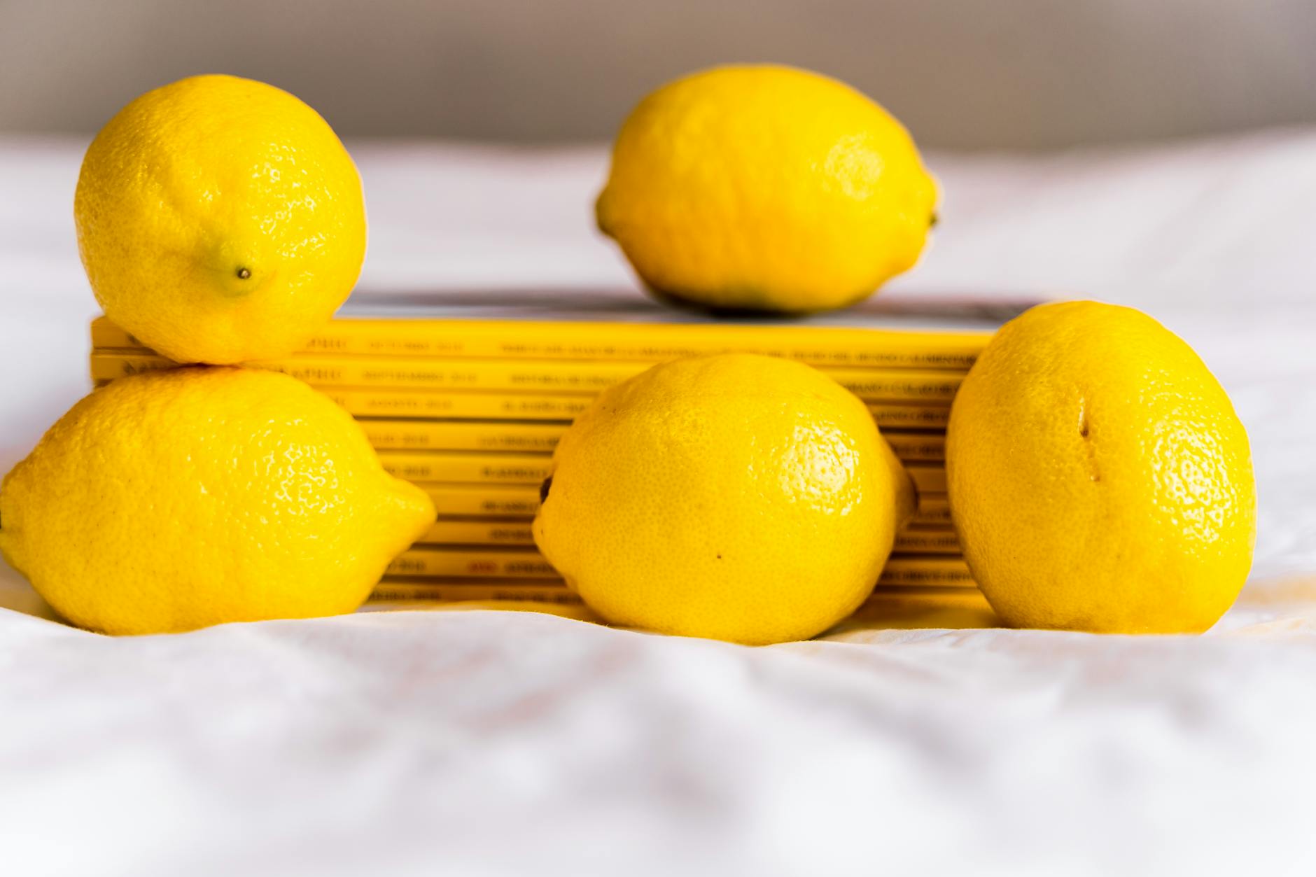 Close-up of hands holding a sleek lemon vibrator, representing mindful pleasure without pressure